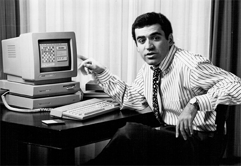 Man gestures at a computer with a chess game on screen
